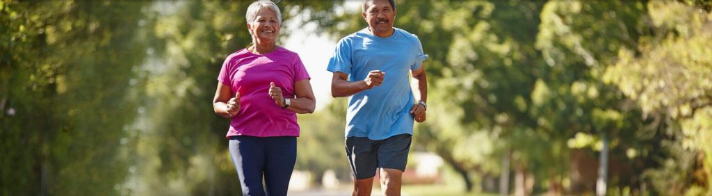 man and women running together in a park after seeing a Orthopaedic and Spine Specialist